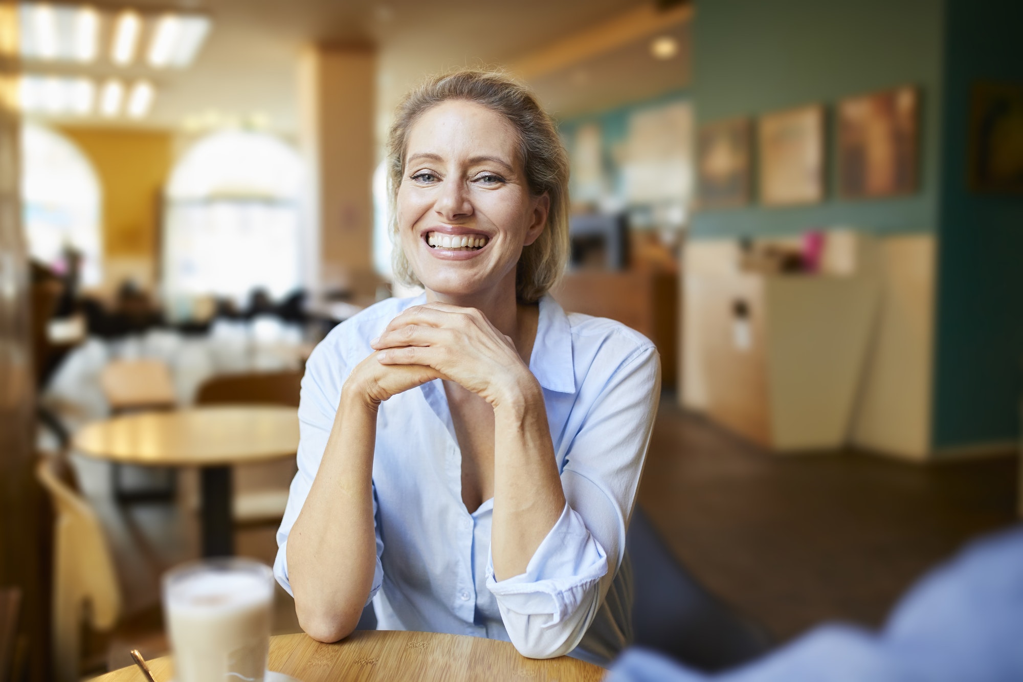 portrait-of-happy-woman-in-a-cafe.jpg